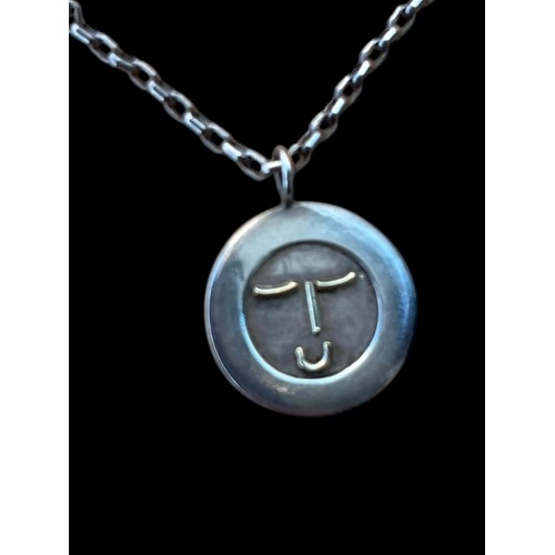 219 - A SILVER HAPPY FACE PENDANT ON A SILVER CHAIN