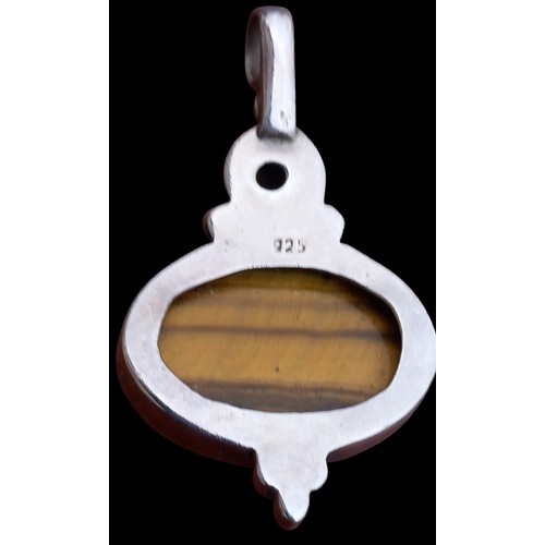 283 - A SILVER TIGERS EYE PENDANT