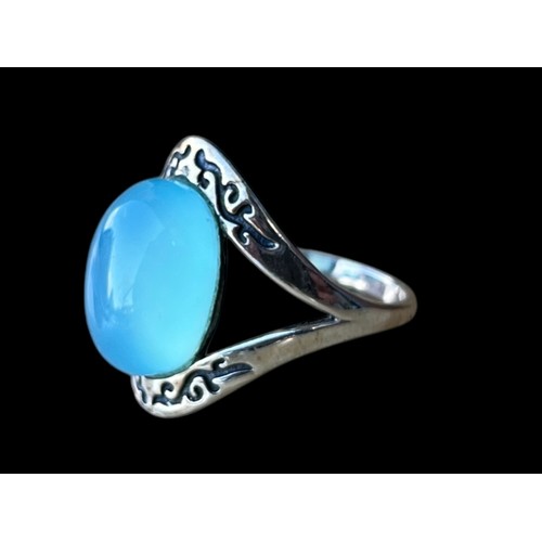 282 - A SILVER RING SET WITH ORNATE SETTING AND  LARGE MOONSTONE STYLE STONE