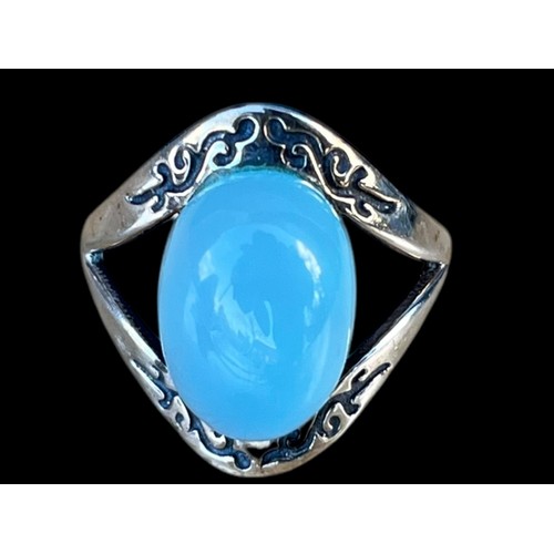 282 - A SILVER RING SET WITH ORNATE SETTING AND  LARGE MOONSTONE STYLE STONE