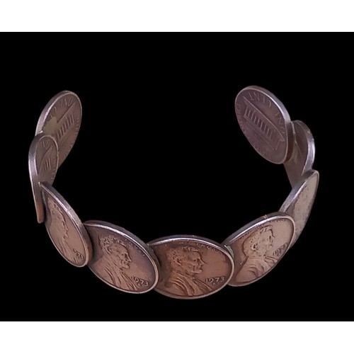 189 - A UNIQUE BANGLE MADE FROM 1973 COPPER AMERICAN COINS