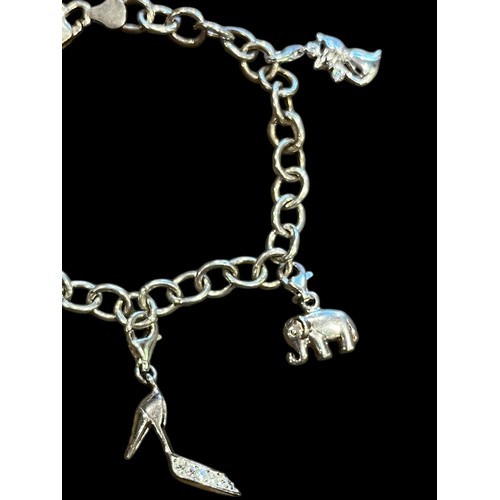 210 - A SILVER CHARM BRACELET SET WITH 4 CHARMS (ELEPHANT, HIGH HEEL, HANDBAG & CAT) 13.2g