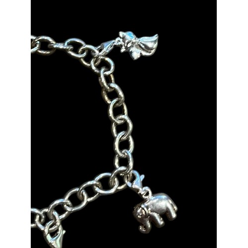 210 - A SILVER CHARM BRACELET SET WITH 4 CHARMS (ELEPHANT, HIGH HEEL, HANDBAG & CAT) 13.2g