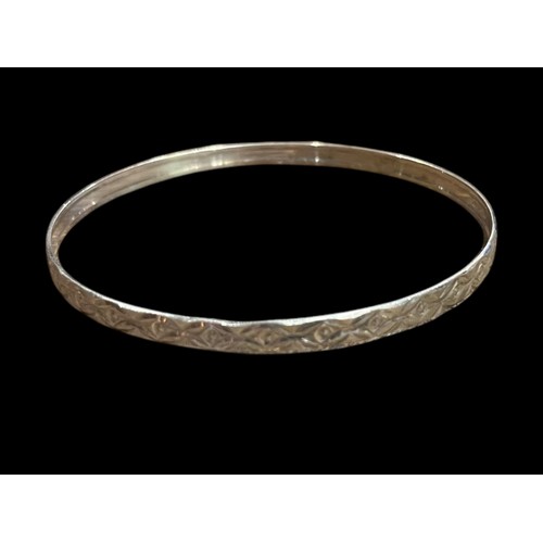 213 - AN ORNATE SILVER BANGLE