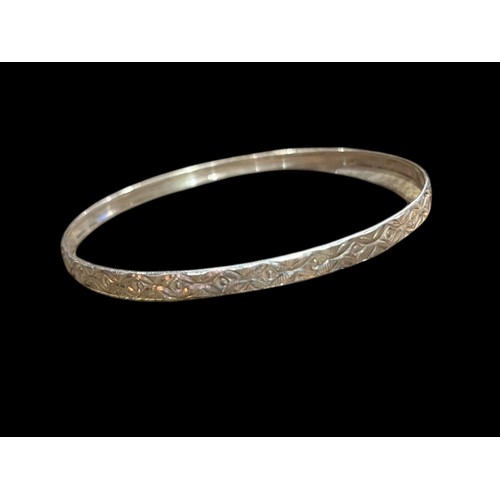 213 - AN ORNATE SILVER BANGLE