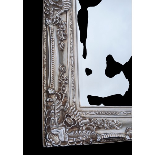 137 - A HEAVILY ORNATE SILVER FRAMED BEVELL EDGE MIRROR 47