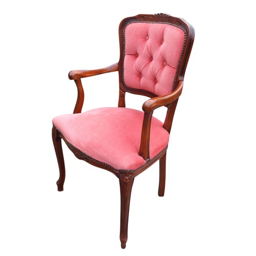 311 - A CARVED BUTTONED BACK ARMCHAIR