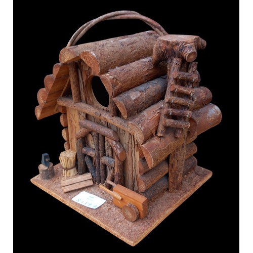 320 - A HIGHLY DECORATIVE WOODEN LOG CABIN BIRD HOUSE