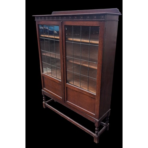 361 - AN OAK LEADED GLASS BOOKCASE ON A BARLEY TWIST LEG 42x55