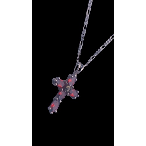 194 - A GEMSET SILVER CROSS ON A SILVER CHAIN