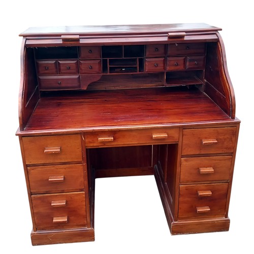 314 - A NEAT MULTI DRAWERED ROLLED TOPPED DESK (SOME DAMAGE)