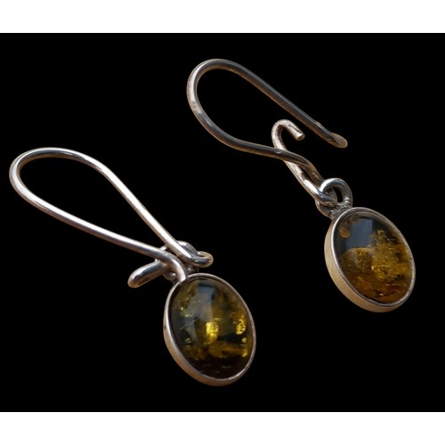 144 - A PAIR OF AMBER SET SILVER EARRINGS