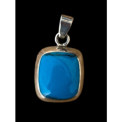 244 - A SILVER MOUNTED TURQUOISE PENDANT