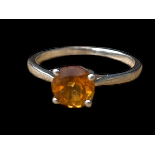 250 - A SILVER RING SET WITH AN ORANGE STONE