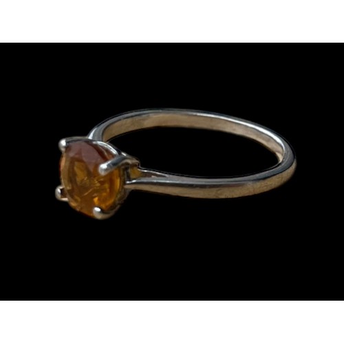 250 - A SILVER RING SET WITH AN ORANGE STONE