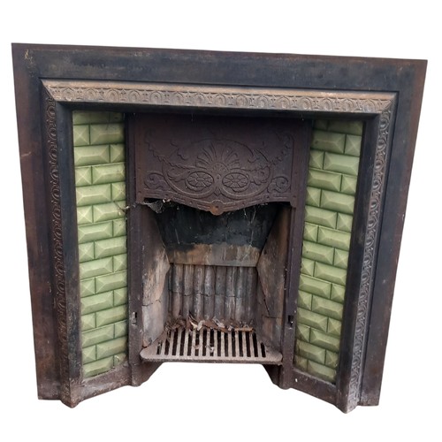 288 - AN ANTIQUE CAST FIREPLACE WITH GREEN TILES  38X39