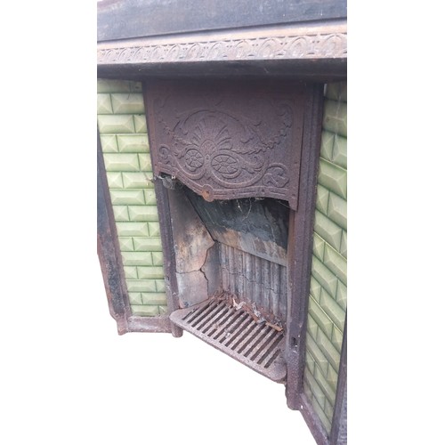 288 - AN ANTIQUE CAST FIREPLACE WITH GREEN TILES  38X39