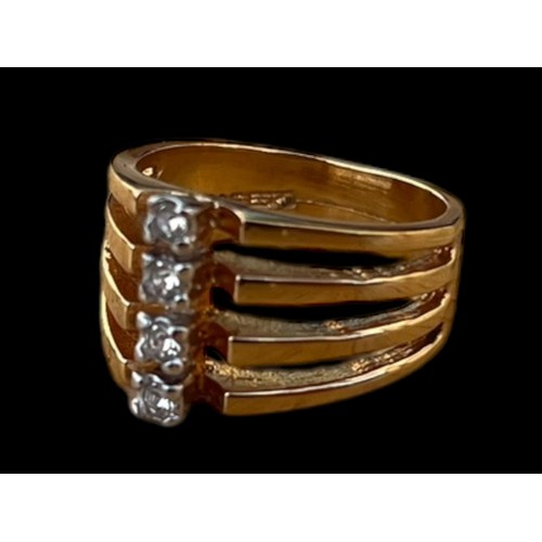 A GOLD TONE 4 STONE SET RING