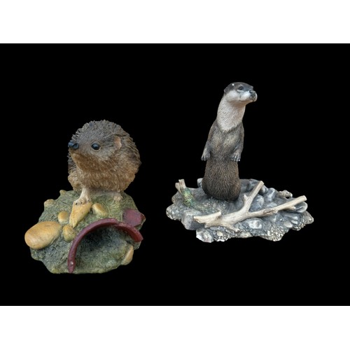 394 - A BORDER FINE ARTS OTTER AND A COALPORT HEDGEHOG