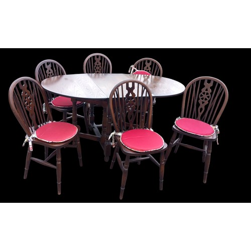 41 - A HIGH QUALITY OAK DROPLEAF TABLE WITH 6 MATCHING WHEEL BACK SADDLE SEAT OAK CHAIRS BY JAYCEE FURNIT... 