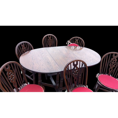 41 - A HIGH QUALITY OAK DROPLEAF TABLE WITH 6 MATCHING WHEEL BACK SADDLE SEAT OAK CHAIRS BY JAYCEE FURNIT... 