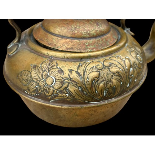 22 - AN ORNATE BRASS KETTLE WITH AN EBONY HANDLE