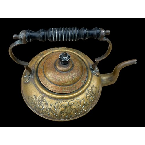 22 - AN ORNATE BRASS KETTLE WITH AN EBONY HANDLE