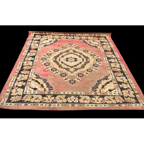 79 - A RED PATTERNED RUG MEASURING 180 x 250