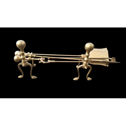 98 - A COPPER AND BRASS FIRE DOGS AND MATCHING COMPANION SET