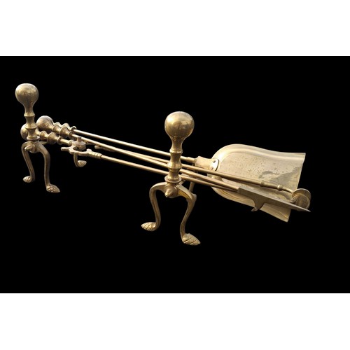 98 - A COPPER AND BRASS FIRE DOGS AND MATCHING COMPANION SET