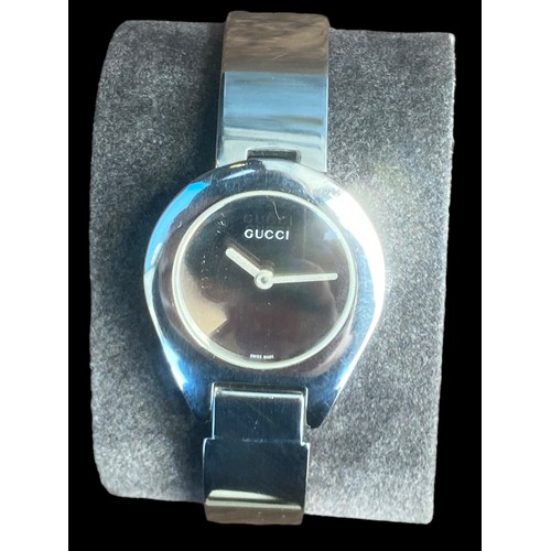 235 - LADIES GUCCI STAINLESS STEEL BANGLE WATCH FEATURE CLASP ,MIRROR PLAIN DIAL  QURTZ AND WORKING SAPPHI... 