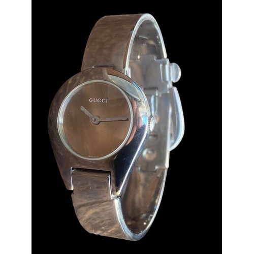 235 - LADIES GUCCI STAINLESS STEEL BANGLE WATCH FEATURE CLASP ,MIRROR PLAIN DIAL  QURTZ AND WORKING SAPPHI... 