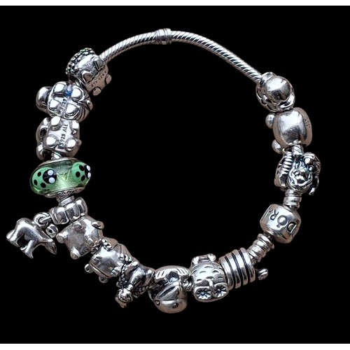 283 - A HEAVY GENIUNE SILVER PANDORA BRACELET WITH CHARMS (72.5G)
