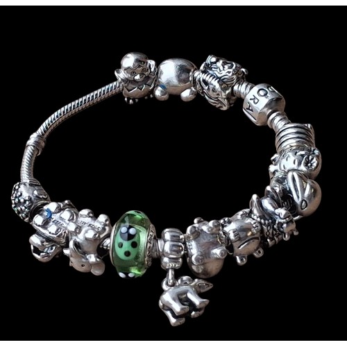 283 - A HEAVY GENIUNE SILVER PANDORA BRACELET WITH CHARMS (72.5G)