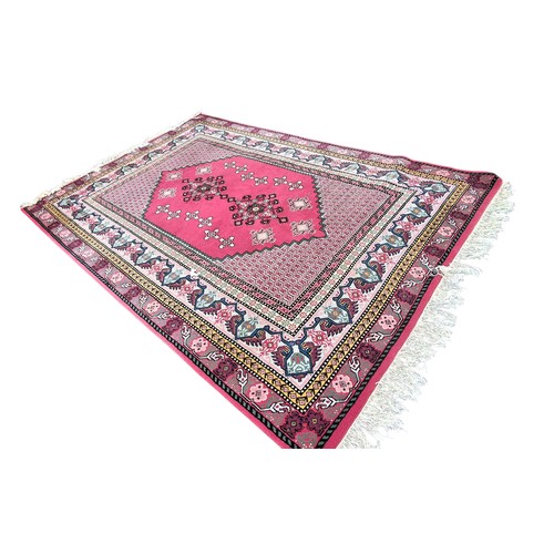10 - A LARGE RED PATTERNED RUG