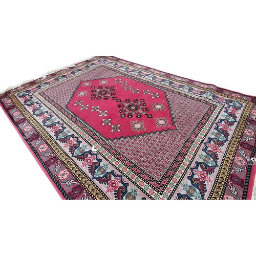 10 - A LARGE RED PATTERNED RUG