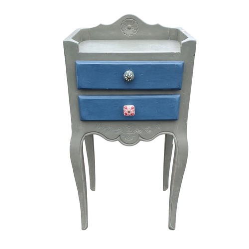 107 - A PAINTED BEDSIDE CUPBOARD WITH 2 DRAWERS