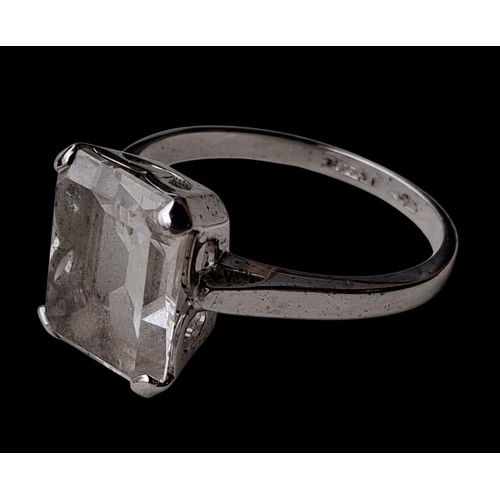 300 - A SILVER RING WITH A LARGE CLEAR STONE