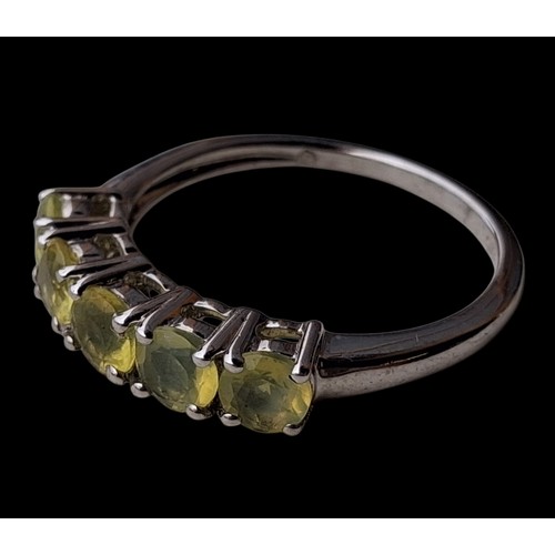 305 - A SILVER RING SET WITH YELLOW STONES