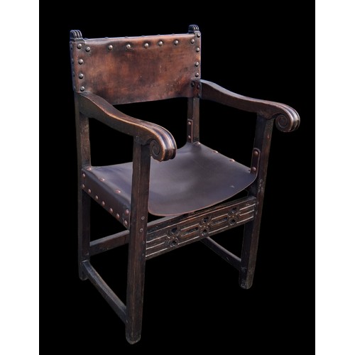 331 - AN ANTIQUE CARVED OAK CHAIR IN THE ANTIQUE STUDDED LEATHER FINISH