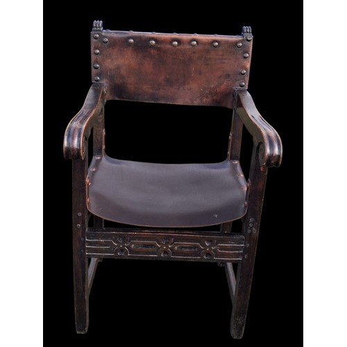 331 - AN ANTIQUE CARVED OAK CHAIR IN THE ANTIQUE STUDDED LEATHER FINISH