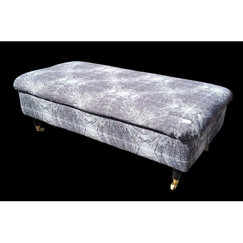 121 - A GREY POUFFE ON CASTORS WITH STORAGE