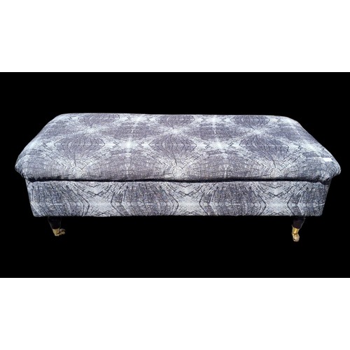 121 - A GREY POUFFE ON CASTORS WITH STORAGE