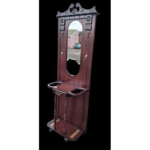 64 - A MIRRORED HALL STAND WITH LION HEAD HOOKS