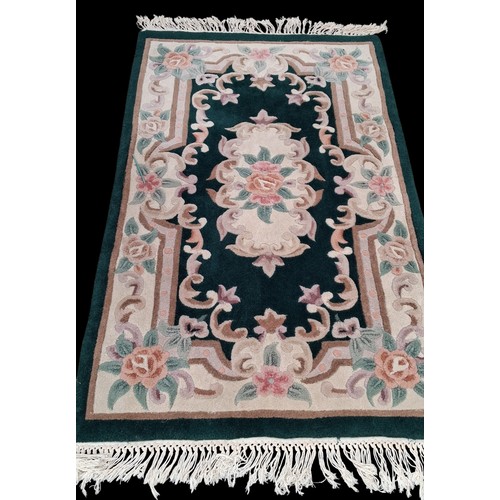 76 - A GREEN PATTERNED RUG