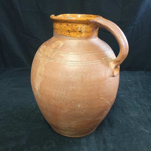 150 - Antique rustic hand-made large terracotta jug with a pale honey slip glaze on both external and inte... 