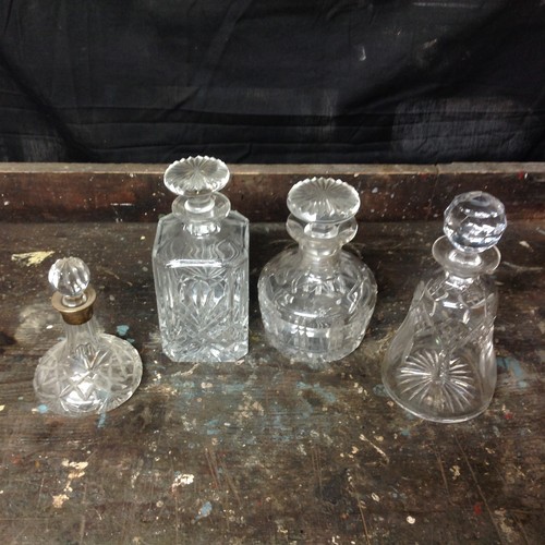 66 - Four Glass Decanters - one silver topped