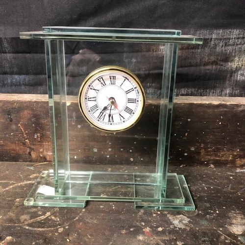 317 - A Small Glass Quartz Clock.
W17cm x H17cm x D6cm 
Working