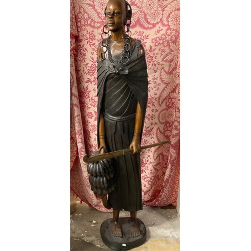 79 - African Wooden Sculpture - R. Kyengo (d.1993). 'Kikuyu woman carrying baby and bananas'. Carved wood... 