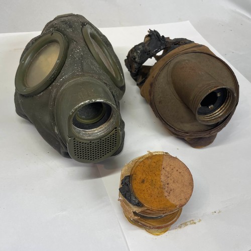 99 - A pair of World War II German Gas Masks with Spare Lenses